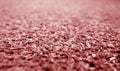 red color artificial grass close-up with blur background Royalty Free Stock Photo