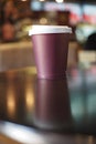 red color Blank take away kraft coffee cup on table ,