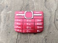 Red color broken mobile keypad put on road Royalty Free Stock Photo