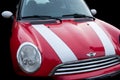 Red Color Car With White Stripes Mini Cooper Parked On Street Isolated in black background Royalty Free Stock Photo