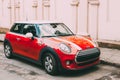 Red Color Car With White Stripes Mini Cooper Parked On Street In Old Part European Town. Royalty Free Stock Photo