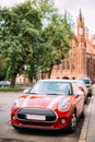 Red Color Car With White Stripes Mini Cooper Parked On Street On Royalty Free Stock Photo