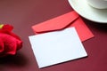 Red color envelope, tea and rose flower on red background