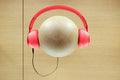 Red color headphones display on wood ball view