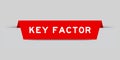 Red inserted label with word key factor on gray background