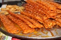 Red color jalebi ready for sell in local market.Jalebi, also known as jilapi, jilebi, jilipi, zulbia, jerry, mushabak, or zalabia