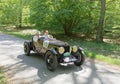 Red color Lagonda Rapier Special classic car from 1935 driving on a country road