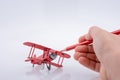 Red color pen in touch with little metal model airplane Royalty Free Stock Photo