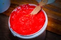 red color of plastisol ink in white plastic barrel.