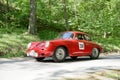 Red color Porche 356 B Karmann Coupe classic car from 1961 driving on a country road Royalty Free Stock Photo