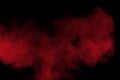 Red color powder explosion on black background. Freeze motion of red dust particles splash Royalty Free Stock Photo