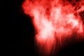 Red color powder explosion on black background. Mauve red color cloud. Royalty Free Stock Photo