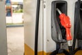 A Red color of refuel nozzle head at gasoline station. Royalty Free Stock Photo