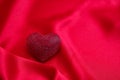 Red color ruby heart jewel on empty silk background. Valentine day, love celebration Royalty Free Stock Photo