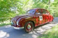 Red color Tatra T600 Tatraplan classic car from 1951 driving on a country road