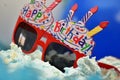 Red color toy sun glass with happy birthday candles Royalty Free Stock Photo