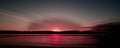 Red colored coastal sunrise seascape cloudscape. Royalty Free Stock Photo