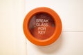 A red colored emergency break glass panel in case of a fire emergency Royalty Free Stock Photo