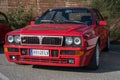 Red-colored Lancia Delta HF parked on the street