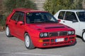 Red-colored Lancia Delta HF parked on the street