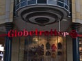 Red colored logo of German outdoor supply chain Globetrotter above shop entrance of the company\'s branch.