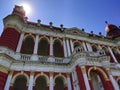 Red colored Palace of encient India under the shining Sun with some white clouds in blue sky.