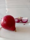 Red colored peeled and fresh spicy onion cut three part cut