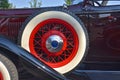 Exterior spare tire on front running board of an old classic car Royalty Free Stock Photo