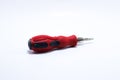 Red colored screwdriver often used by craftsmen on an isolated white background Royalty Free Stock Photo
