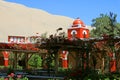 Red colored tower dome against the awesome sand dunes of Huacachina desert, the oasis town of Huacachina, Ica region, Peru Royalty Free Stock Photo