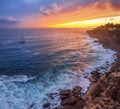 Red colorful sunset and vivid dramatic sky at rocky shore of the Atlantic ocean