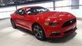 Red colour ford mustang car at showroom