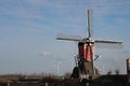 Red colourd old four corner wooden windmill at Zoeterwoude in the Netherlands Royalty Free Stock Photo