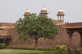 Red coloured Indian building with ornate arches and white domes Royalty Free Stock Photo