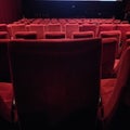 Red coloured seats in rows in a cinema hall