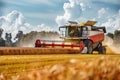 Red combine harvester in wheat field under clear blue sky during summer harvest Royalty Free Stock Photo