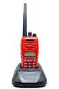 Red communication radio with charging cradle isolate on white background with clipping path. Walkie-Talkies with Battery charger Royalty Free Stock Photo