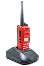 Red communication radio with charging cradle isolate on white background with clipping path. Walkie-Talkies with Battery charger Royalty Free Stock Photo