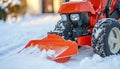 Red Compact Tractor Equipped With Snow Blower Clears a Snowy Driveway, Winter Snow Removal