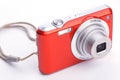 Red compact zoom digital camera over white Royalty Free Stock Photo