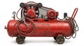 Red compressor with a hose attached to it. The hose is connected to a red nozzle. The compressor is old and rusty Royalty Free Stock Photo