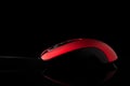 Red computer mouse on a black reflective background Royalty Free Stock Photo