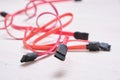 Red computer wires for hard drive on light background Royalty Free Stock Photo