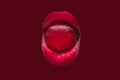 Red concept. Sweets in the female mouth. Beautiful lipstick and cosmetics. Sweet life. Lollipop on tongue. Damage sugar