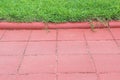 Red concrete block pravement blank and green grass field on background Royalty Free Stock Photo