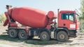 Red concrete mixer vehicle on the construction site Royalty Free Stock Photo