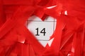 Red confetti on calendar with number 14, closeup. Valentine`s Day celebration