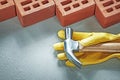 Red construction bricks protective gloves claw hammer on concret Royalty Free Stock Photo