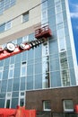 Red construction crane boom in process of finishing office building Royalty Free Stock Photo