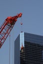 Red construction crane before a modern office building Royalty Free Stock Photo